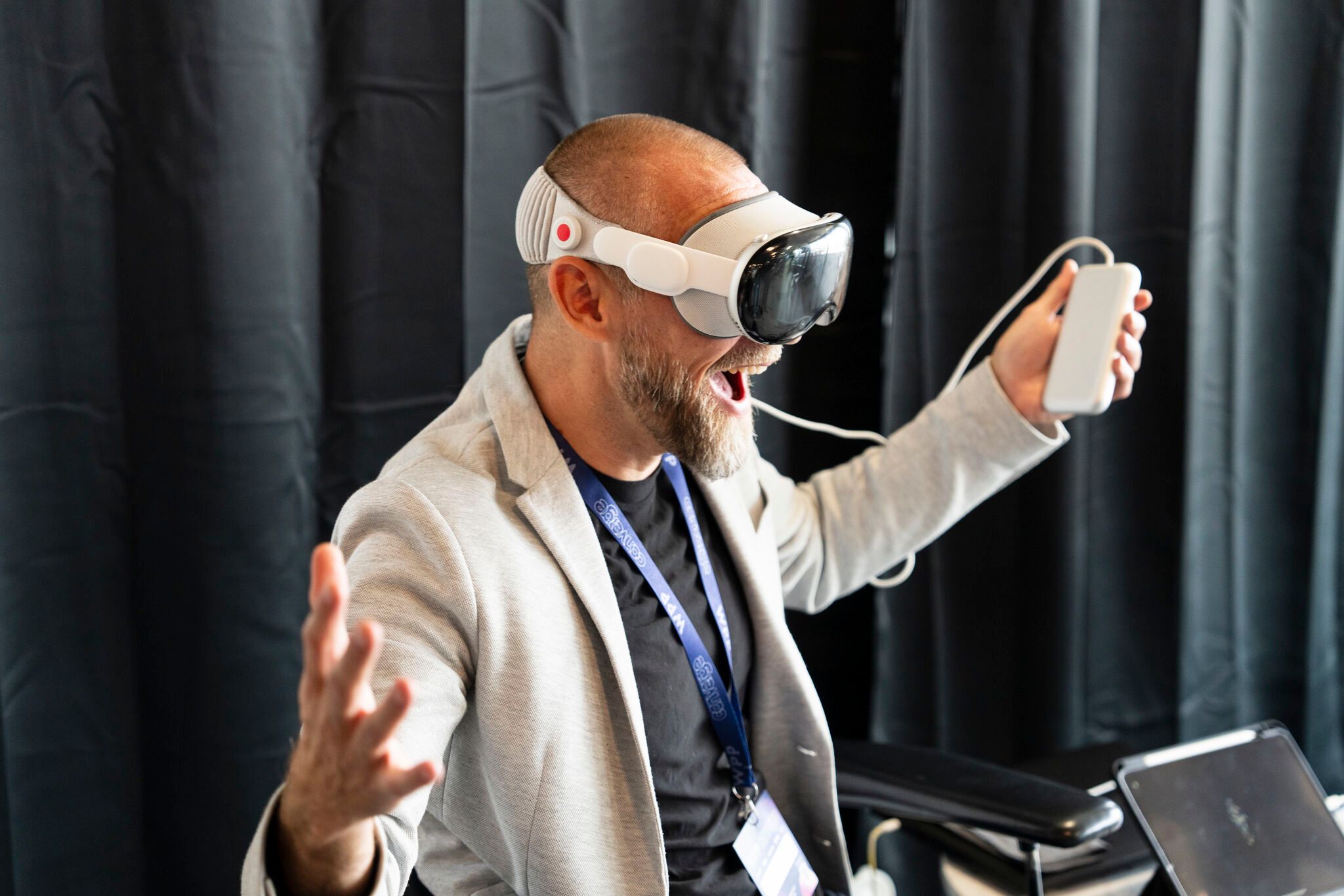 Person raising their hands and smiling while experiencing Apple Vision Pro.